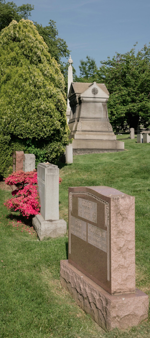Several memorial monuments in a peaceful cemetery landscape